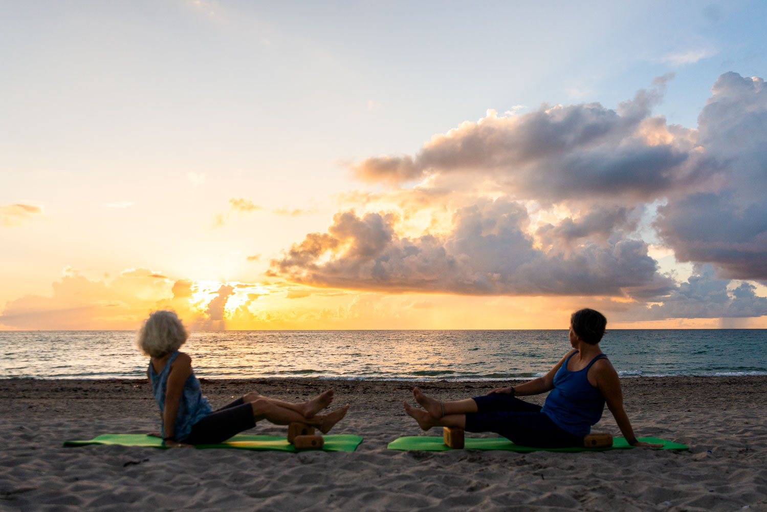 photo of michele and stephanie doing block therapy on a beach at sunrise